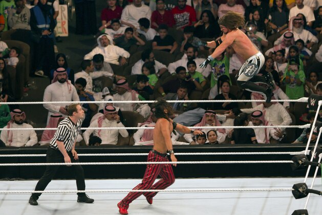 World Wrestling Entertainment stars AJ Styles, top, and Shinsuke Nakamura, wrestle during their match at the