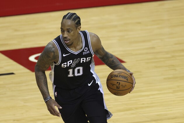 San Antonio Spurs' DeMar DeRozan controls the ball during the second half of an NBA basketball game against the Houston Rockets in Houston, Thursday, Dec. 17, 2020. (Carmen Mandato/Pool Photo via AP)