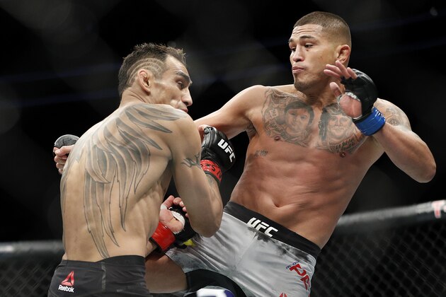 Tony Ferguson, left, fights Anthony Pettis during a lightweight mixed martial arts bout at UFC 229 in Las Vegas, Saturday, Oct. 6, 2018. (AP Photo/John Locher)