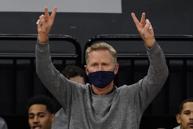 Golden State Warriors coach Steve Kerr signals his team during the first half of an NBA preseason basketball game against the Sacramento Kings in Sacramento, Calif., Thursday, Dec. 17, 2020. The Warriors won 113-109. (AP Photo/Rich Pedroncelli)