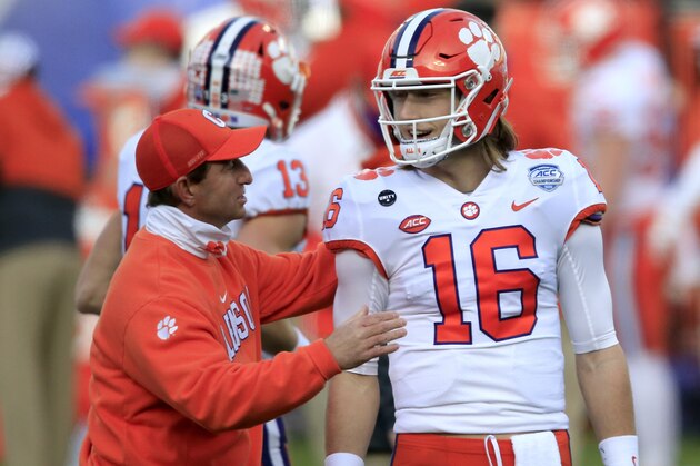 Clemson head coach Dabo Swinney speaks with uarterback Trevor Lawrence (16) before the start of the Atlantic Coast Conference championship NCAA college football game against Notre Dame, Saturday, Dec. 19, 2020, in Charlotte, N.C. (AP Photo/Brian Blanco)