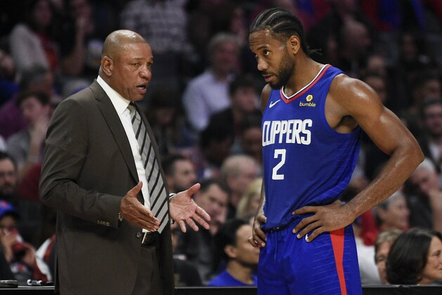 Los Angeles Clippers forward Kawhi Leonard, right, speaks with head coach Doc Rivers after being taken out of the game during the second half of an NBA basketball game against the New Orleans Pelicans in Los Angeles, Sunday, Nov. 24, 2019. The Clippers won 134-109. (AP Photo/Kelvin Kuo)