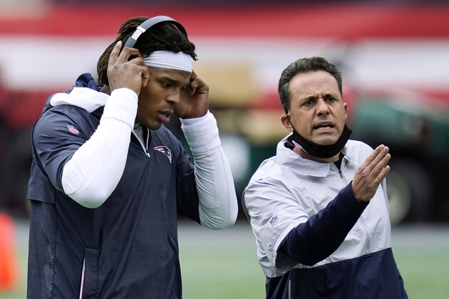 New England Patriots quarterback Cam Newton, left, stands beside quarterback coach Jedd Fisch before an NFL football game against the San Francisco 49ers, Monday, Oct. 26, 2020, in Foxborough, Mass. (AP Photo/Charles Krupa)