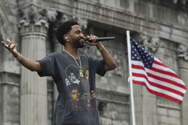 Rapper Big Sean performs outside the Michigan Central train depot, Tuesday, June 19, 2018, in Detroit. Ford Motor Co. is embarking on a 4-year renovation of the 105-year-old depot and 17-story office tower just west of downtown. The massive project is expected to increase the automaker's footprint in the city where the company was founded, provide space for electric and autonomous vehicle testing and research, and spur investment in the surrounding neighborhood.(AP Photo/Carlos Osorio)