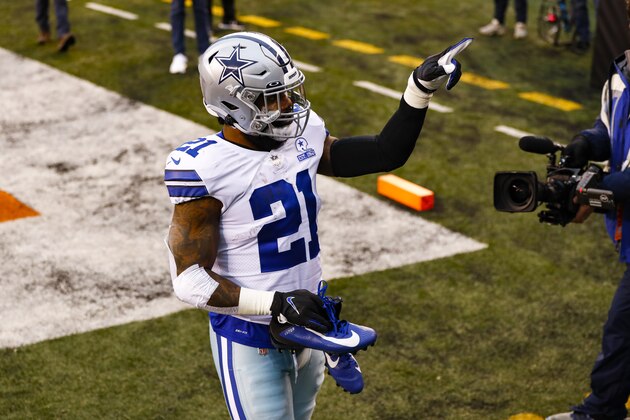Dallas Cowboys running back Ezekiel Elliott (21) gives his cletes to a fan following an NFL football game against the Cincinnati Bengals in Cincinnati, Sunday, Dec. 13, 2020. The Cowboys defeated the Bengals 30-7. (AP Photo/Aaron Doster)
