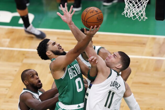 Boston Celtics' Jayson Tatum (0) shoots over Milwaukee Bucks' Brook Lopez (11) during the first half of an NBA basketball game Wednesday, Dec. 23, 2020, in Boston. (AP Photo/Michael Dwyer)