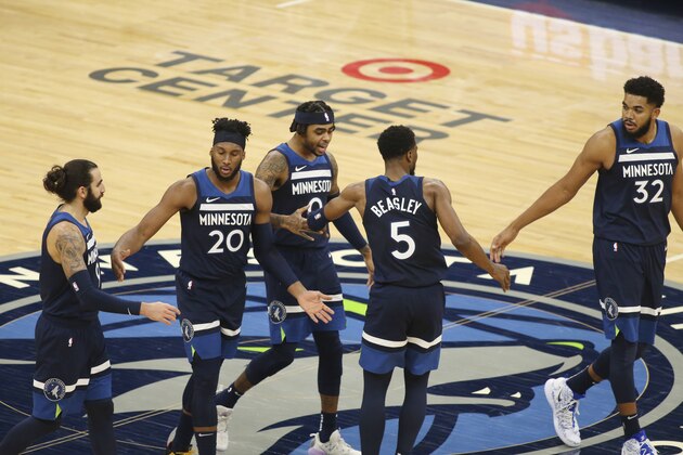 Minnesota Timberwolves' Ricky Rubio, Josh Okogie (20), D'Angelo Russell (0), Malik Beasley (5) and Karl-Anthony Towns celebrate during the fourth quarter of the team's NBA basketball game against the Detroit Pistons, Wednesday, Dec. 23, 2020, in Minneapolis. (AP Photo/Andy Clayton-King)