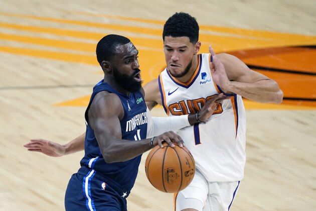 Dallas Mavericks guard Tim Hardaway Jr. drives past Phoenix Suns guard Devin Booker (1) during the first half of an NBA basketball game Wednesday, Dec. 23, 2020, in Phoenix. (AP Photo/Rick Scuteri) Dallas Mavericks guard Tim Hardaway Jr. drives past Phoenix Suns guard Devin Booker (1) during the first half of an NBA basketball game Wednesday, Dec. 23, 2020, in Phoenix. (AP Photo/Rick Scuteri)
