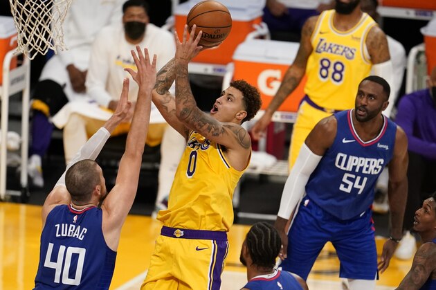 Los Angeles Lakers forward Kyle Kuzma (0) shoots over Los Angeles Clippers center Ivica Zubac (40) during the first half of an NBA basketball game Tuesday, Dec. 22, 2020, in Los Angeles. (AP Photo/Marcio Jose Sanchez)