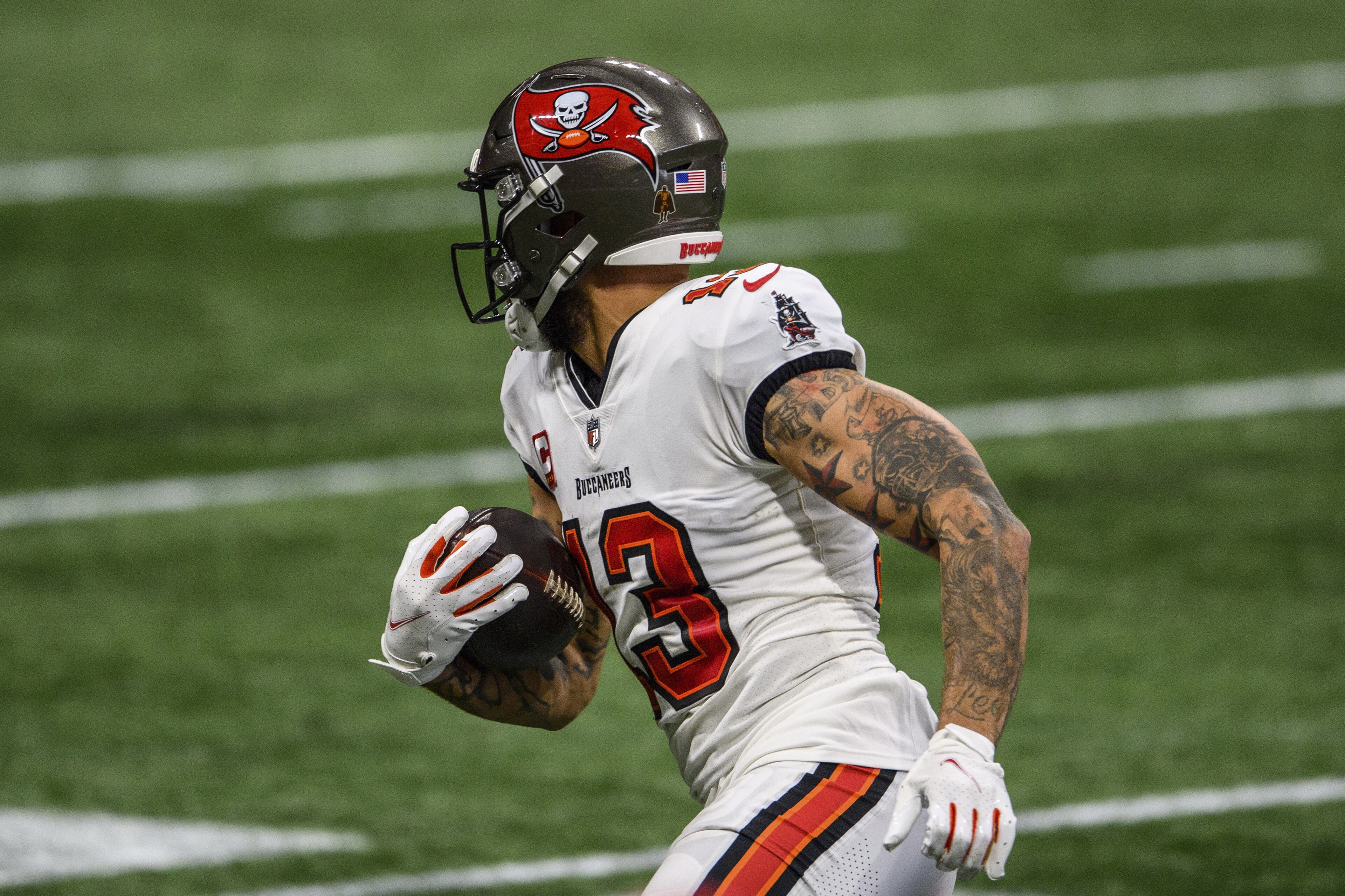 Tampa Bay Buccaneers wide receiver Mike Evans (13) runs the ball during the second half of an NFL football game against the Atlanta Falcons, Sunday, Dec. 20, 2020, in Atlanta. The Tampa Bay Buccaneers won 31-27. (AP Photo/Danny Karnik)