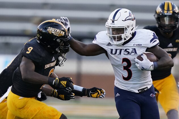UTSA running back Sincere McCormick (3) fends off an attempted tackle by Southern Mississippi defensive back Malik Shorts (9) during the second half of an NCAA college football game, Saturday, Nov. 21, 2020, in Hattiesburg, Miss. UTSA won 23-20. (AP Photo/Rogelio V. Solis) UTSA running back Sincere McCormick (3) fends off an attempted tackle by Southern Mississippi defensive back Malik Shorts (9) during the second half of an NCAA college football game, Saturday, Nov. 21, 2020, in Hattiesburg, Miss. UTSA won 23-20. (AP Photo/Rogelio V. Solis)