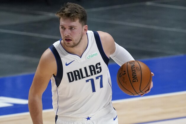 Dallas Mavericks guard Luka Doncic advances the ball up court against the Minnesota Timberwolves in the first half of an NBA preseason basketball game in Dallas, Thursday, Dec. 17, 2020. (AP Photo/Tony Gutierrez)