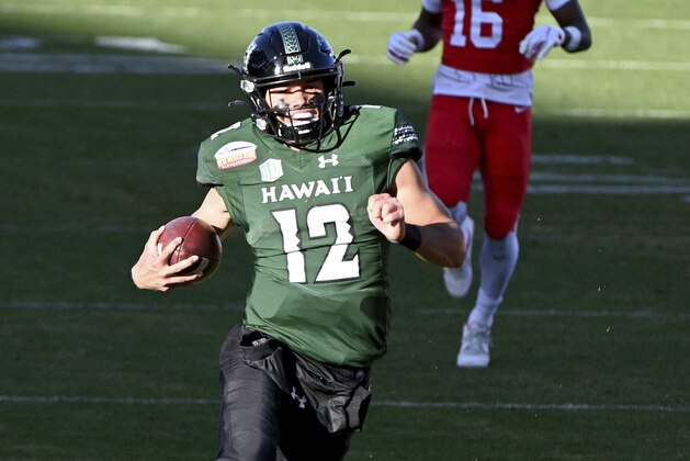 Hawaii quarterback Chevan Cordeiro (12)(12) runs upfield for a long gain in the second quarter of the New Mexico Bowl NCAA college football game in Frisco, Texas, Thursday, Dec. 24, 2020. (AP Photo/Matt Strasen)