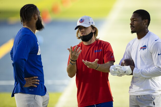 Buffalo Bills wide receiver Gabriel Davis (13) and Buffalo Bills wide receiver Stefon Diggs (14) listen as wide receiver coach Chad Hall speaks before an NFL football game against the Tennessee Titans, Tuesday, Oct. 13, 2020, in Nashville, Tenn. (AP Photo/Brett Carlsen)