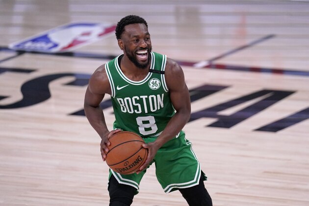 Boston Celtics guard Kemba Walker (8) smiles as he looks to make a pass during the second half of an NBA conference final playoff basketball game against the Miami Heat on Saturday, Sept. 19, 2020, in Lake Buena Vista, Fla. (AP Photo/Mark J. Terrill)