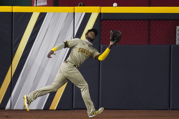 San Diego Padres left fielder Jurickson Profar (10) catches a flyout hit by Los Angeles Dodgers' Enrique Hernandez during the seventh inning in Game 1 of a baseball NL Division Series, Tuesday, Oct. 6, 2020, in Arlington, Texas. (AP Photo/Sue Ogrocki) San Diego Padres left fielder Jurickson Profar (10) catches a flyout hit by Los Angeles Dodgers' Enrique Hernandez during the seventh inning in Game 1 of a baseball NL Division Series, Tuesday, Oct. 6, 2020, in Arlington, Texas. (AP Photo/Sue Ogrocki)