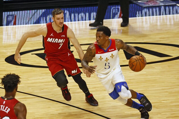 New Orleans Pelicans guard Eric Bledsoe (5) dribbles against Miami Heat guard Goran Dragic (7) during the first half of an NBA basketball game, Friday, Dec. 25, 2020, in Miami. (AP Photo/Joel Auerbach)