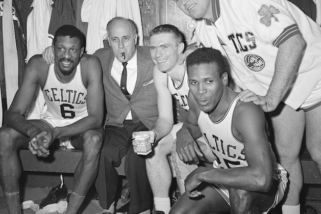 Victorious Celtics smile happily with their cigar smoking Coach