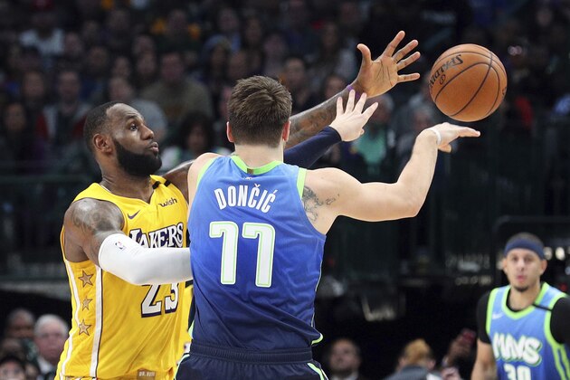 Los Angeles Lakers forward LeBron James (23) guards Dallas Mavericks forward Luka Doncic (77) during the second half of an NBA basketball game Friday, Jan. 10, 2020, in Dallas. (AP Photo/Richard W. Rodriguez)