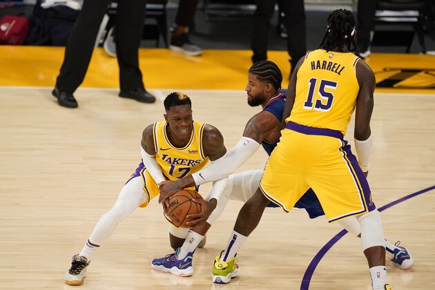 Los Angeles Lakers guard Dennis Schroder, right, is defended by Los Angeles Clippers guard Paul George, center, during the second half of an NBA basketball game Tuesday, Dec. 22, 2020, in Los Angeles. (AP Photo/Marcio Jose Sanchez) Los Angeles Lakers guard Dennis Schroder, right, is defended by Los Angeles Clippers guard Paul George, center, during the second half of an NBA basketball game Tuesday, Dec. 22, 2020, in Los Angeles. (AP Photo/Marcio Jose Sanchez)