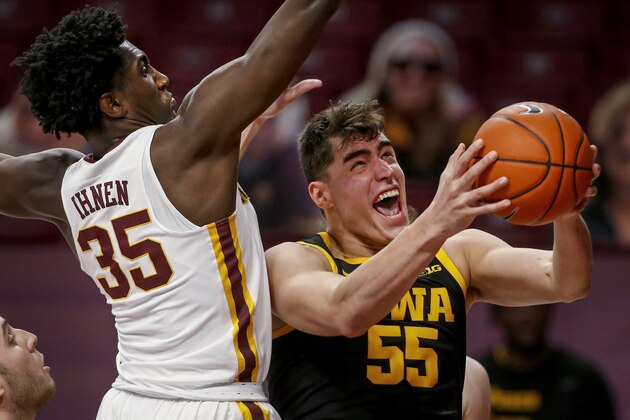 Iowa center Luka Garza (55) works to the basket as Minnesota forward Isaiah Ihnen (35) defends during the second half of an NCAA college basketball game Friday, Dec. 25, 2020, in Minneapolis. Minnesota won 102-95 in overtime. (AP Photo/Bruce Kluckhohn)