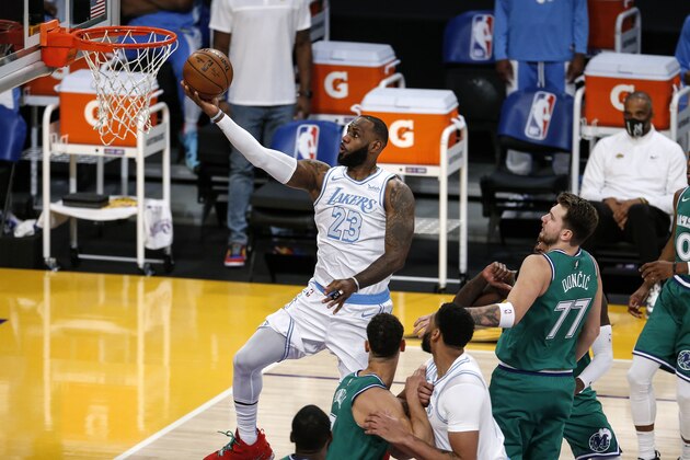 Los Angeles Lakers' LeBron James (23) goes up for a layup against the Dallas Mavericks during the first half of an NBA basketball game Friday, Dec. 25, 2020, in Los Angeles. (AP Photo/Ringo H.W. Chiu)