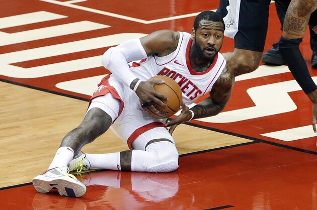 Houston Rockets guard John Wall (1) comes up with a loose ball in front of San Antonio Spurs forward LaMarcus Aldridge (12) during the first half of an NBA basketball game Tuesday, Dec. 15, 2020, in Houston. (AP Photo/Michael Wyke)