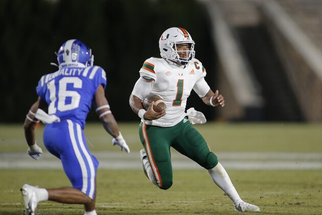 Miami quarterback D'Eriq King (1) carries the football as Duke safety Jaylen Stinson (16) defends during the second half of an NCAA college football game Saturday, Dec. 5, 2020, in Durham, N.C. (Nell Redmond/Pool Photo via AP)
