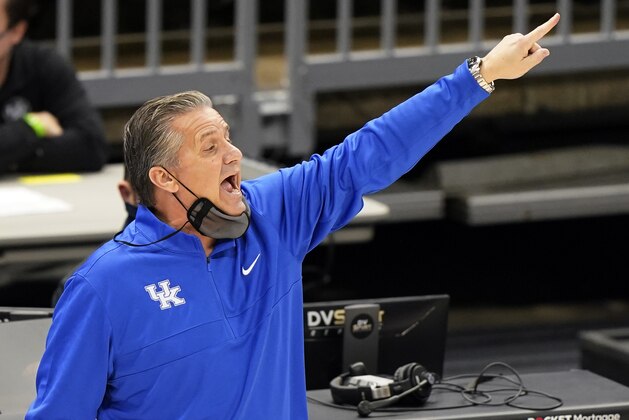 Kentucky head coach John Calipari yells instructions to players in the first half of an NCAA college basketball game against North Carolina, Saturday, Dec. 19, 2020, in Cleveland. (AP Photo/Tony Dejak)