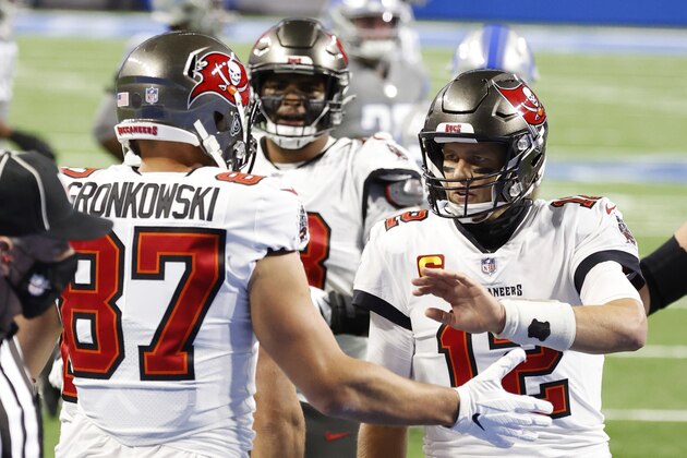 Tampa Bay Buccaneers tight end Rob Gronkowski (87) receives congratulations from quarterback Tom Brady (12) after scoring a touchdown in the first half during an NFL football game, Saturday, Dec. 26, 2020, in Detroit. (AP Photo/Rick Osentoski)