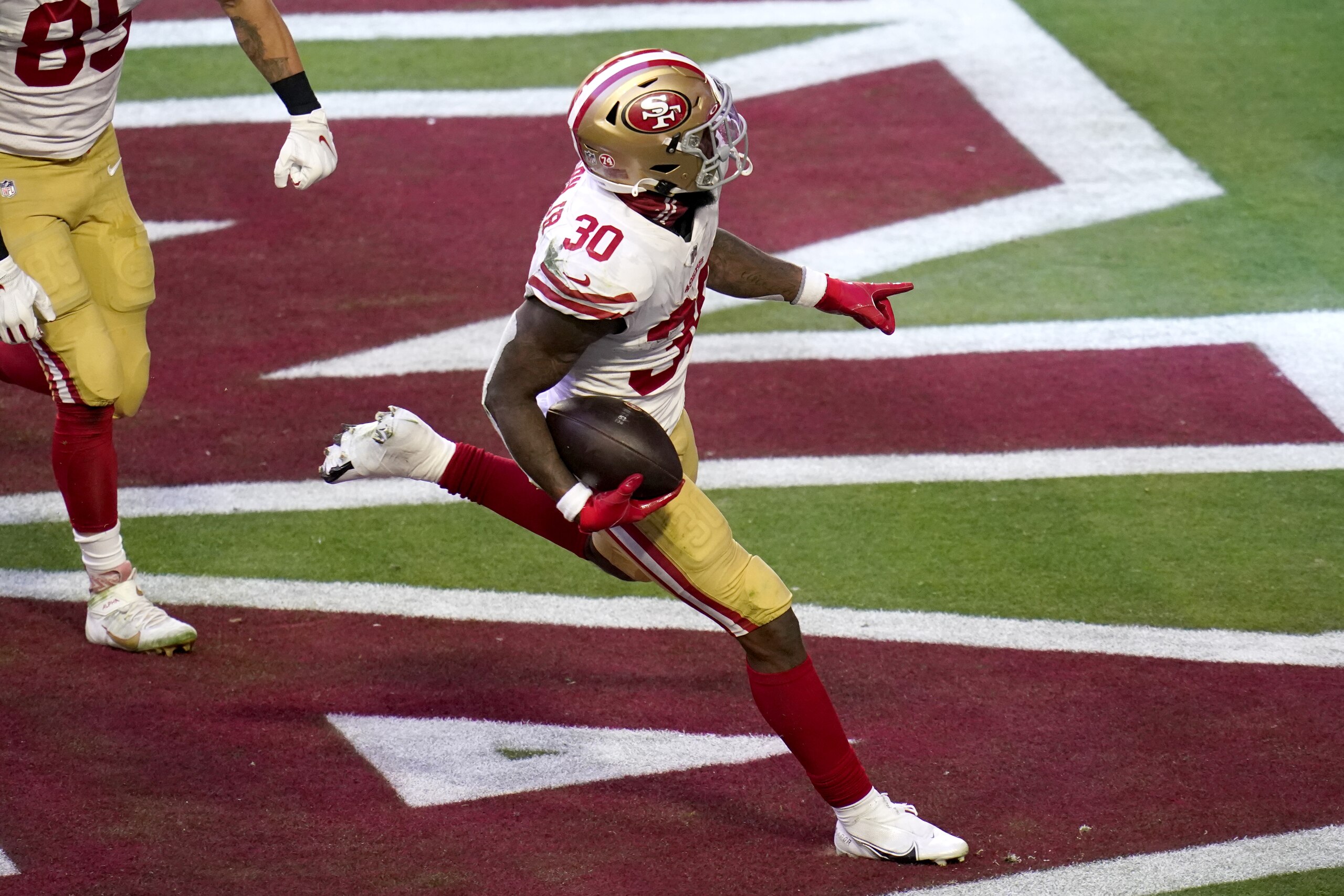 San Francisco 49ers running back Jeff Wilson (30) scores a touchdown against the Arizona Cardinals during the first half of an NFL football game, Saturday, Dec. 26, 2020, in Glendale, Ariz. (AP Photo/Ross D. Franklin) San Francisco 49ers running back Jeff Wilson (30) scores a touchdown against the Arizona Cardinals during the first half of an NFL football game, Saturday, Dec. 26, 2020, in Glendale, Ariz. (AP Photo/Ross D. Franklin)