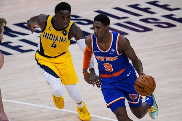 New York Knicks guard RJ Barrett (9) drives on Indiana Pacers guard Victor Oladipo (4) during the second half of an NBA basketball game in Indianapolis, Wednesday, Dec. 23, 2020. The Pacers defeated the Knicks 121-107. (AP Photo/Michael Conroy)