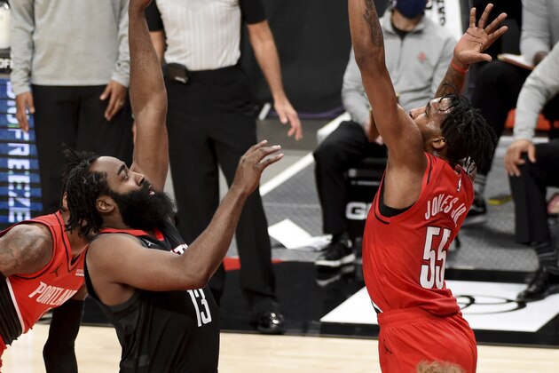 Houston Rockets guard James Harden, left, shoots over Portland Trail Blazers forward Derrick Jones Jr. during the first half of an NBA basketball game in Portland, Ore., Saturday, Dec. 26, 2020. (AP Photo/Steve Dykes)