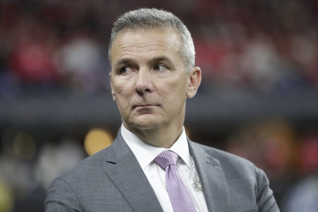 Former Ohio State head coach Urban Meyer watches during the second half of the Big Ten championship NCAA college football game between Ohio State and Wisconsin, Saturday, Dec. 7, 2019, in Indianapolis. (AP Photo/Michael Conroy)