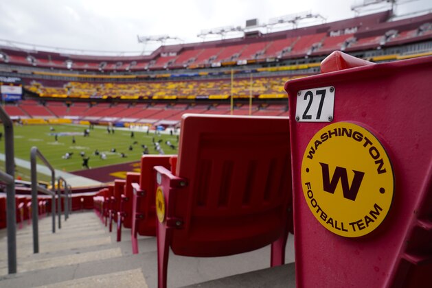 FILE - In this Sunday, Sept. 13, 2020, file photo, seats at Fedex Field display the Washington Football Team logo during pregame warmups of an NFL football game between Washington Football Team and Philadelphia Eagles,  in Landover, Md. The Washington Football Team will allow only friends and family in attendance at FedEx Field on Sunday, Oct. 25, against the Dallas Cowboys, even after Maryland Gov. Larry Hogan allowed teams to fill outdoor stadiums to 10% capacity. A team spokeswoman said there would be no change from Washingtonâ€™s previous arrangement to not sell tickets to fans for this game at the stadium in Landover, Maryland. At 10% capacity, roughly 8,000 fans would be allowed, something that remains possible later this season. (AP Photo/Susan Walsh, File)