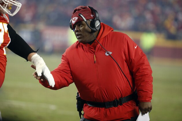 FILE - In this Jan. 20, 2019, file photo, Kansas City Chiefs offensive coordinator Eric Bieniemy greets a player during the second half of the team's AFC championship NFL football game against the New England Patriots in Kansas City, Mo. One year ago, Bieniemy and San Francisco 49ers defensive coordinator Robert Saleh missed out on the coaching carousel despite being coordinators of the two Super Bowl teams. The two figure to be near the top of many of the lists of possible head coaching candidates again this offseason when the NFL is hoping some new rules lead to more opportunities for minority coaches. (AP Photo/Charlie Riedel, File)