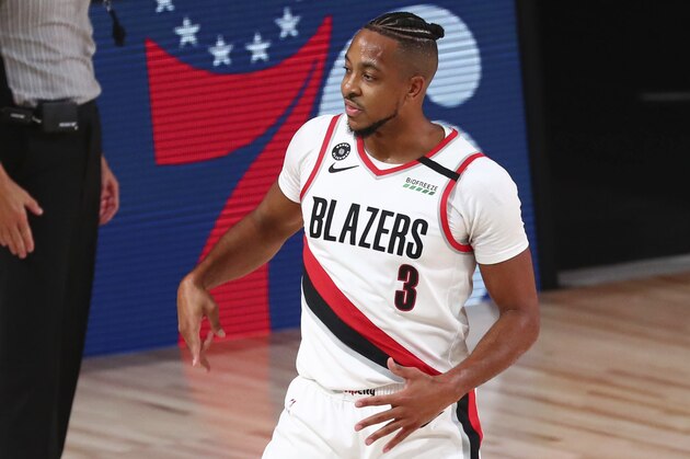 Portland Trail Blazers guard CJ McCollum (3) celebrates after scoring a three-point basket against the Los Angeles Lakers in the first half of Game 3 of an NBA basketball first-round playoff series, Saturday, Aug. 22, 2020, in Lake Buena Vista, Fla. (Kim Klement/Pool Photo via AP)