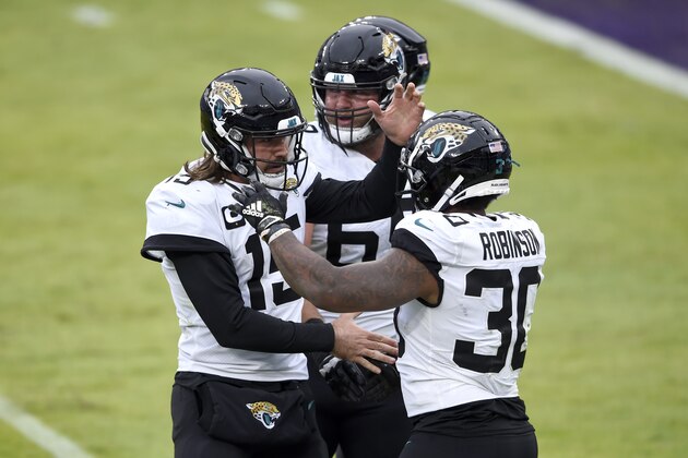 Jacksonville Jaguars quarterback Gardner Minshew II (15) and running back James Robinson (30) react after they connected for a touchdown pass against the Baltimore Ravens during the second half of an NFL football game, Sunday, Dec. 20, 2020, in Baltimore. (AP Photo/Gail Burton)