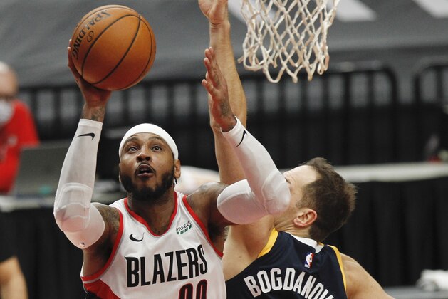 Portland Trail Blazers forward Carmelo Anthony, left, shoots as Utah Jazz forward Bojan Bogdanovic, right, defends during the second half of an NBA basketball game in Portland, Ore., Wednesday, Dec. 23, 2020. The Jazz defeated the Trail Blazers 120-100. (AP Photo/Steve Dipaola)