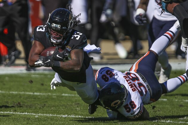 Jacksonville Jaguars running back Dare Ogunbowale (33) is tackled by Chicago Bears linebacker Roquan Smith (58) during the first half of an NFL football game, Sunday, Dec. 27, 2020, in Jacksonville, Fla. (AP Photo/Gary McCullough)