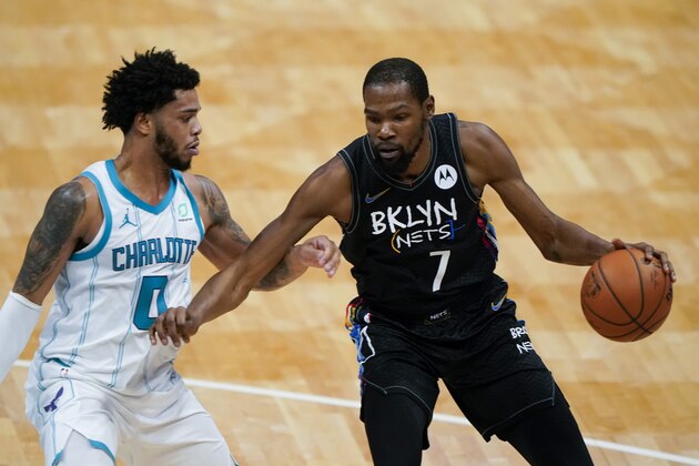 Brooklyn Nets forward Kevin Durant drives around Charlotte Hornets forward Miles Bridges during the first half of an NBA basketball game in Charlotte, N.C., Sunday, Dec. 27, 2020. (AP Photo/Chris Carlson)