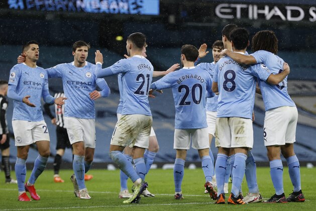 Manchester City's Ferran Torres, center, celebrates with teammates after scoring his side's second goal during the English Premier League soccer match between Manchester City and Newcastle United at the Etihad Stadium in Manchester, England, Saturday, Dec., 26, 2020. (Clive Brunskill/Pool via AP)