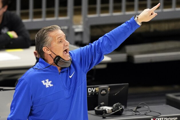 Kentucky head coach John Calipari yells instructions to players in the first half of an NCAA college basketball game against North Carolina, Saturday, Dec. 19, 2020, in Cleveland. (AP Photo/Tony Dejak)
