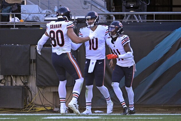 Chicago Bears quarterback Mitchell Trubisky (10) celebrates his touchdown run against the Jacksonville Jaguars with teammates tight end Jimmy Graham (80) and wide receiver Darnell Mooney (11) during the second half of an NFL football game, Sunday, Dec. 27, 2020, in Jacksonville, Fla. (AP Photo/Phelan M. Ebenhack)