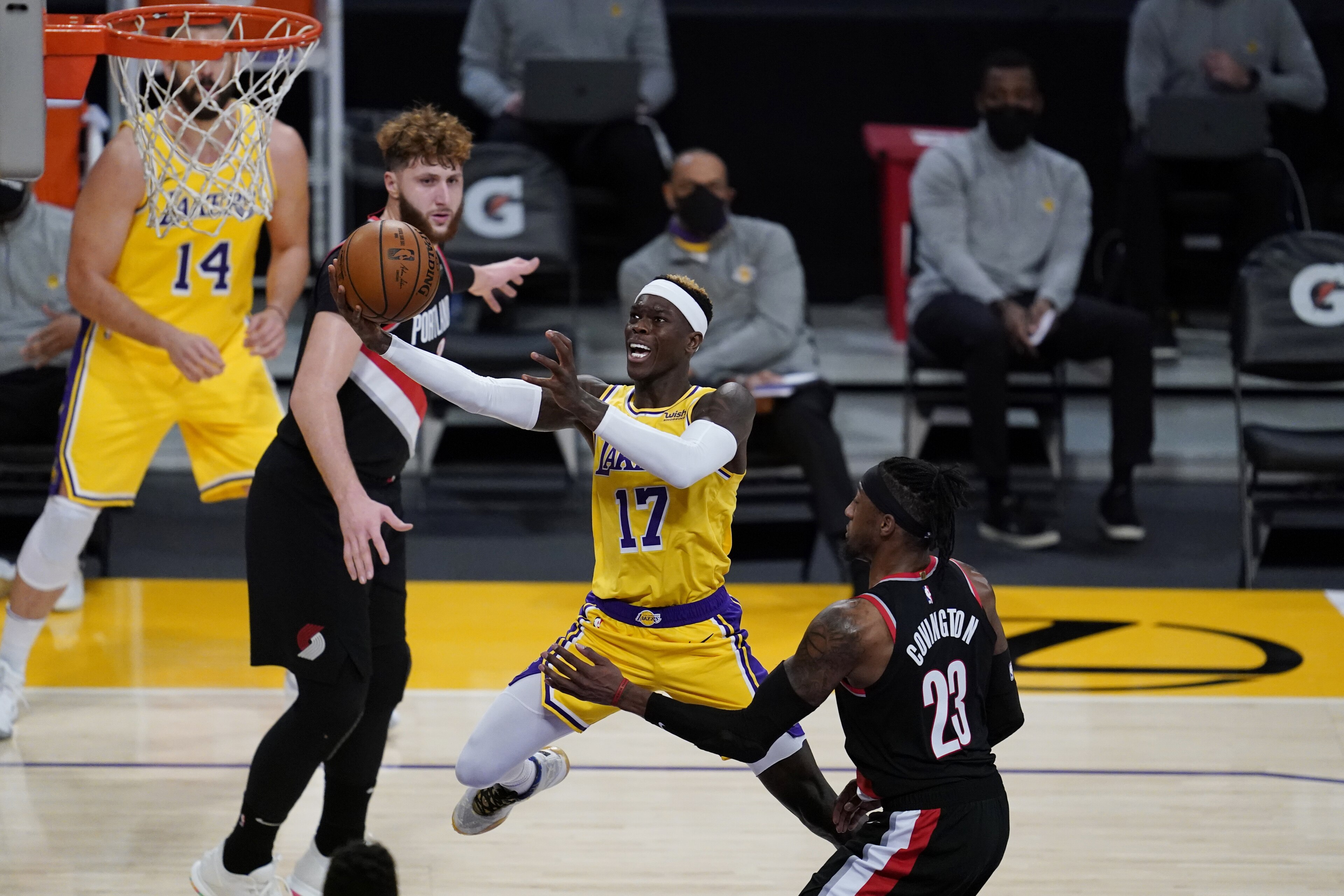 Los Angeles Lakers guard Dennis Schroeder (17) goes up for a shot against Portland Trail Blazers forward Robert Covington (23) during the third quarter of an NBA basketball game Monday, Dec. 28, 2020, in Los Angeles. (AP Photo/Ashley Landis)