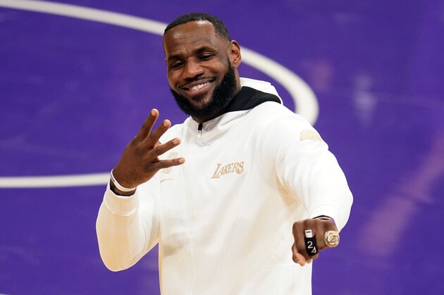 Los Angeles Lakers forward LeBron James reacts after receiving his NBA championship ring before an NBA basketball game against the Los Angeles Clippers, Tuesday, Dec. 22, 2020, in Los Angeles. (AP Photo/Marcio Jose Sanchez)