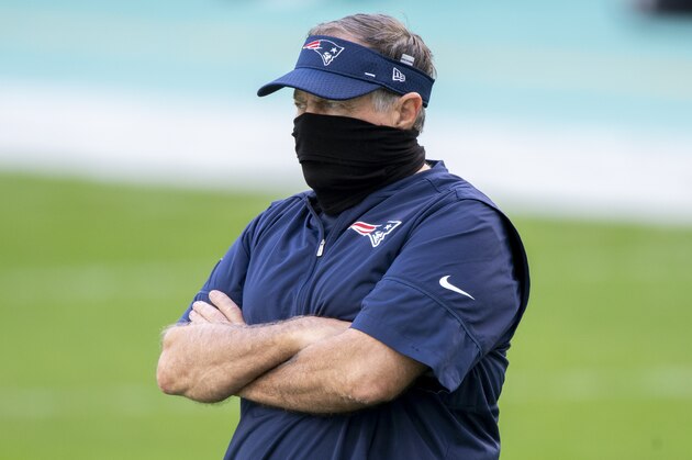 New England Patriots Head Coach Bill Belichick wears a mask as he watches the players warm up on the field before the Patriots take on the Miami Dolphins during an NFL football game, Sunday, Dec. 20, 2020, in Miami Gardens, Fla. (AP Photo/Doug Murray) New England Patriots Head Coach Bill Belichick wears a mask as he watches the players warm up on the field before the Patriots take on the Miami Dolphins during an NFL football game, Sunday, Dec. 20, 2020, in Miami Gardens, Fla. (AP Photo/Doug Murray)