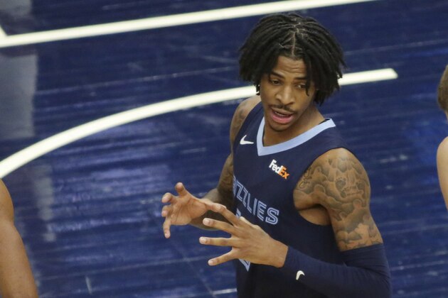 Memphis Grizzlies guard Ja Morant (12) talks to his bench against the Minnesota Timberwolves during an NBA preseason basketball game, Saturday, Dec. 12, 2020 in Minneapolis. (AP Photo/Andy Clayton- King)
