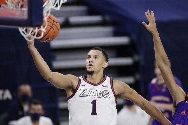 Gonzaga guard Jalen Suggs, left, shoots next to Northwestern State guard Jairus Roberson during the second half of an NCAA college basketball game in Spokane, Wash., Monday, Dec. 21, 2020. (AP Photo/Young Kwak)