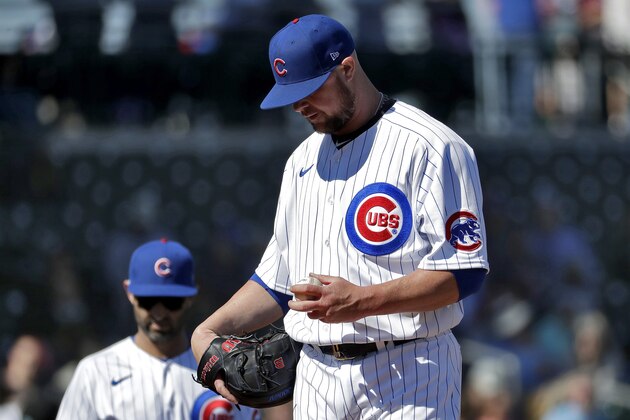 Chicago Cubs pitcher Jon Lester waits to come out of the game during the second inning of a spring training baseball game against the Colorado Rockies, Tuesday, Feb. 25, 2020, in Mesa, Ariz. (AP Photo/Matt York)